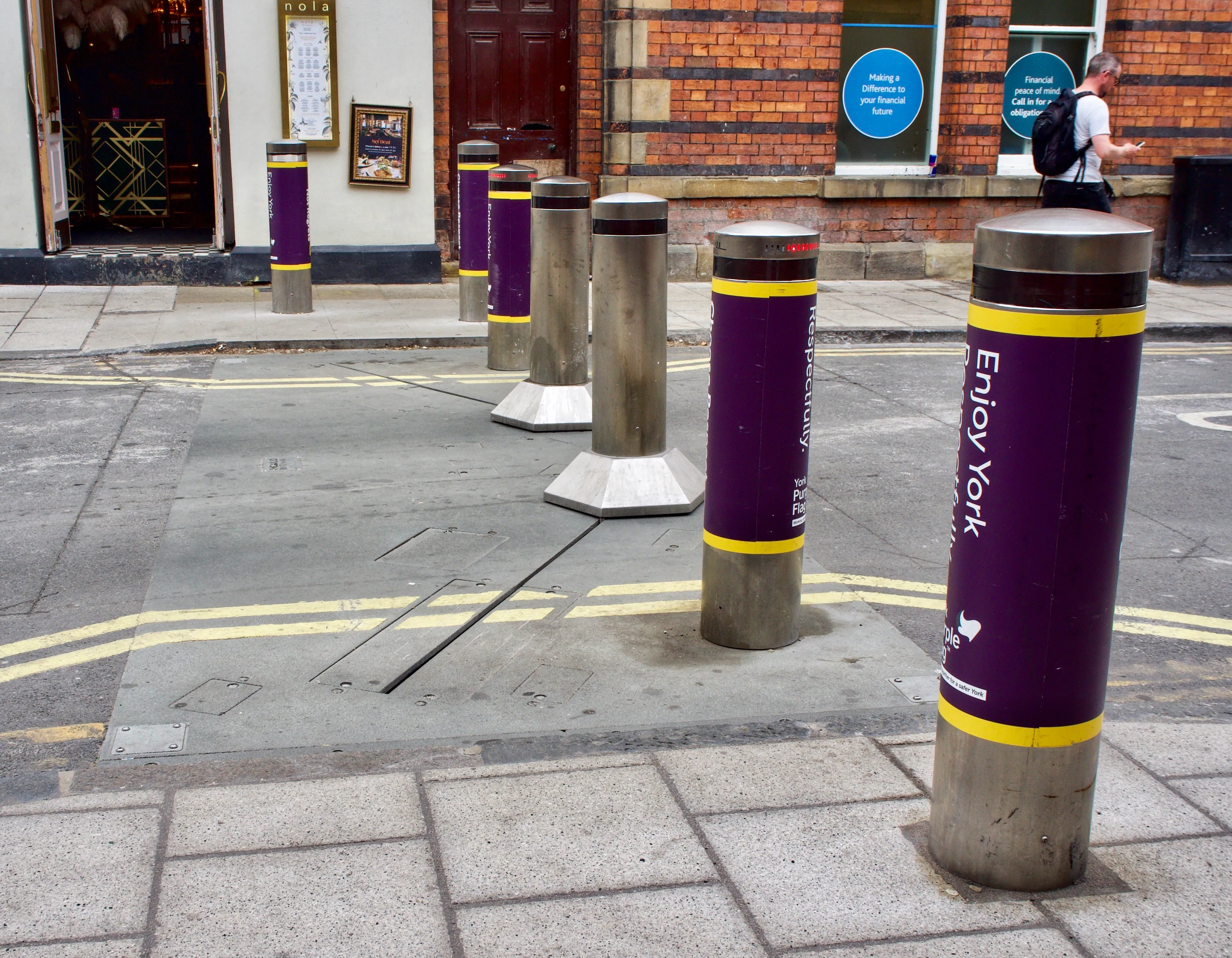 Hostile vehicle mitigation bollards installed at a site perimeter